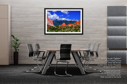 a dining room table with chairs and a picture hanging on the wall