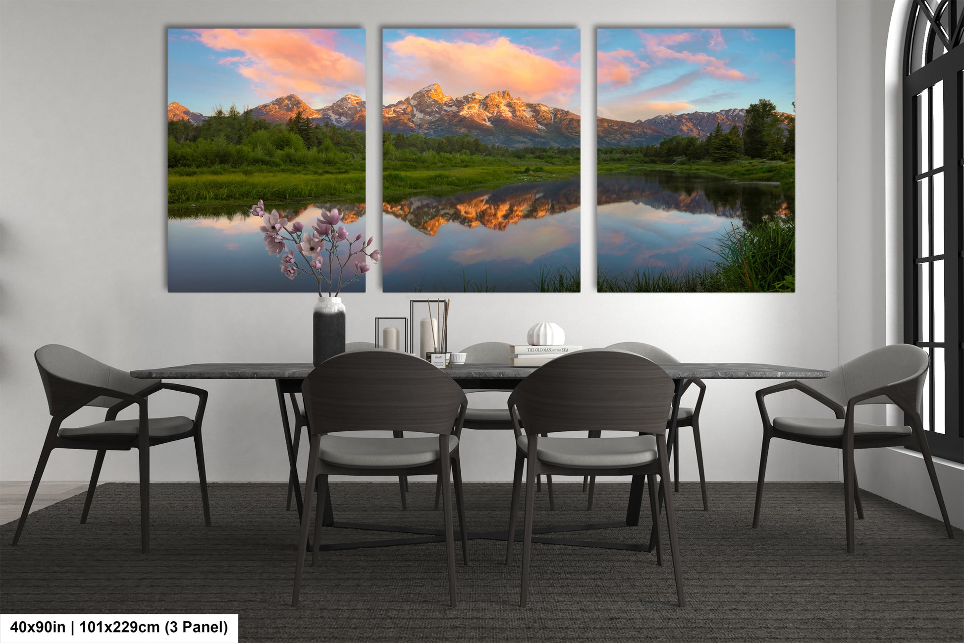 a dining room table with four chairs and a painting on the wall