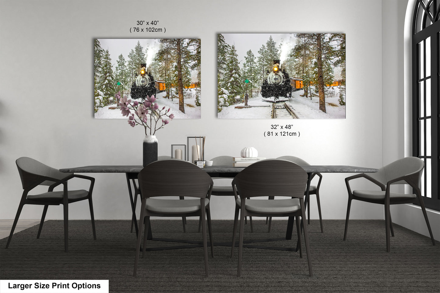 a dining room table with four chairs and two pictures on the wall