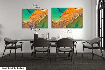 a dining room table with chairs and a painting on the wall