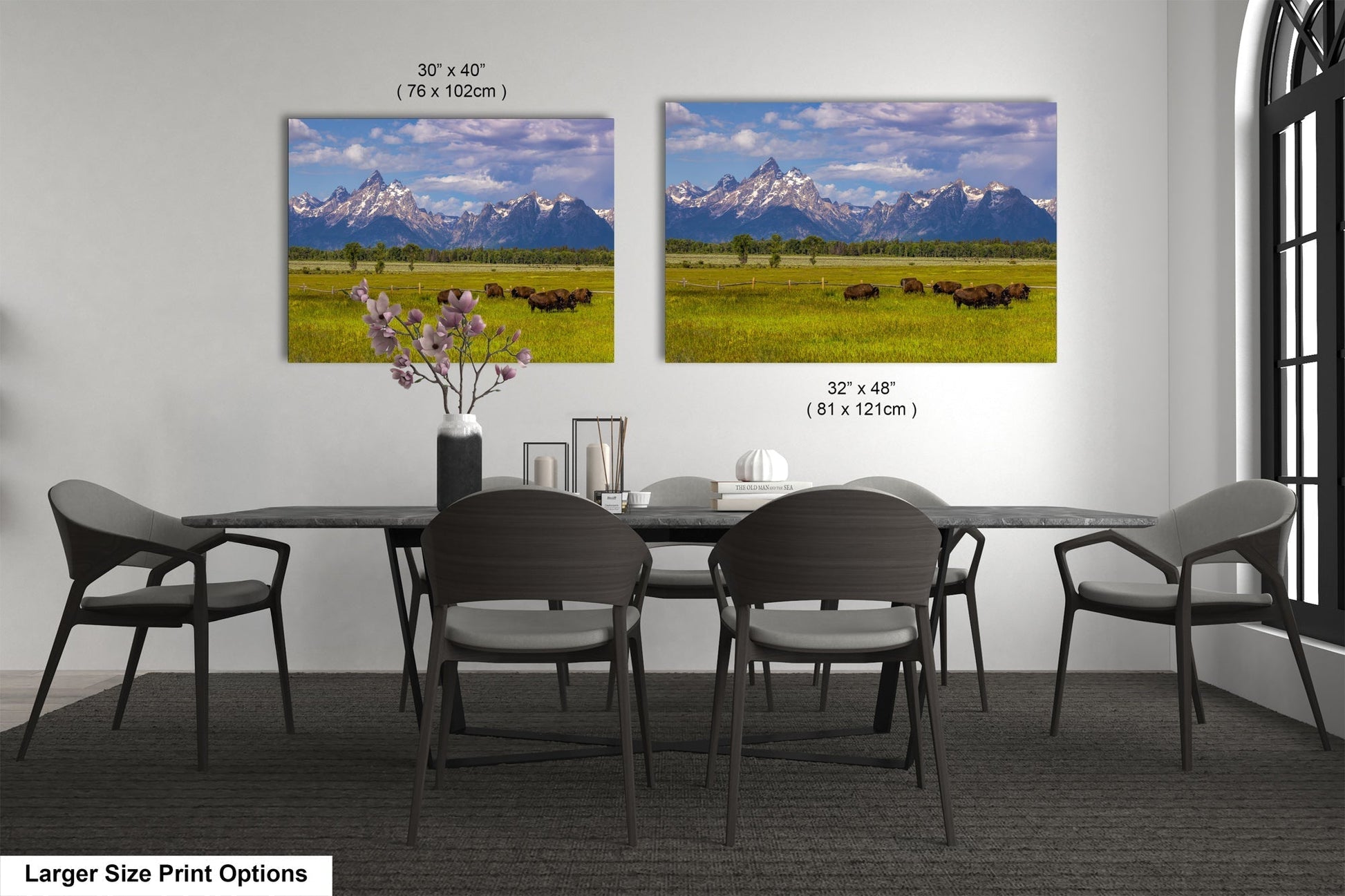 a dining room table with four chairs and a vase of flowers