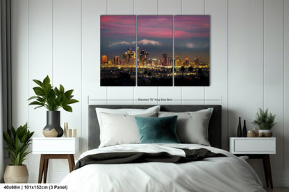 a bedroom with a bed and a picture of a city