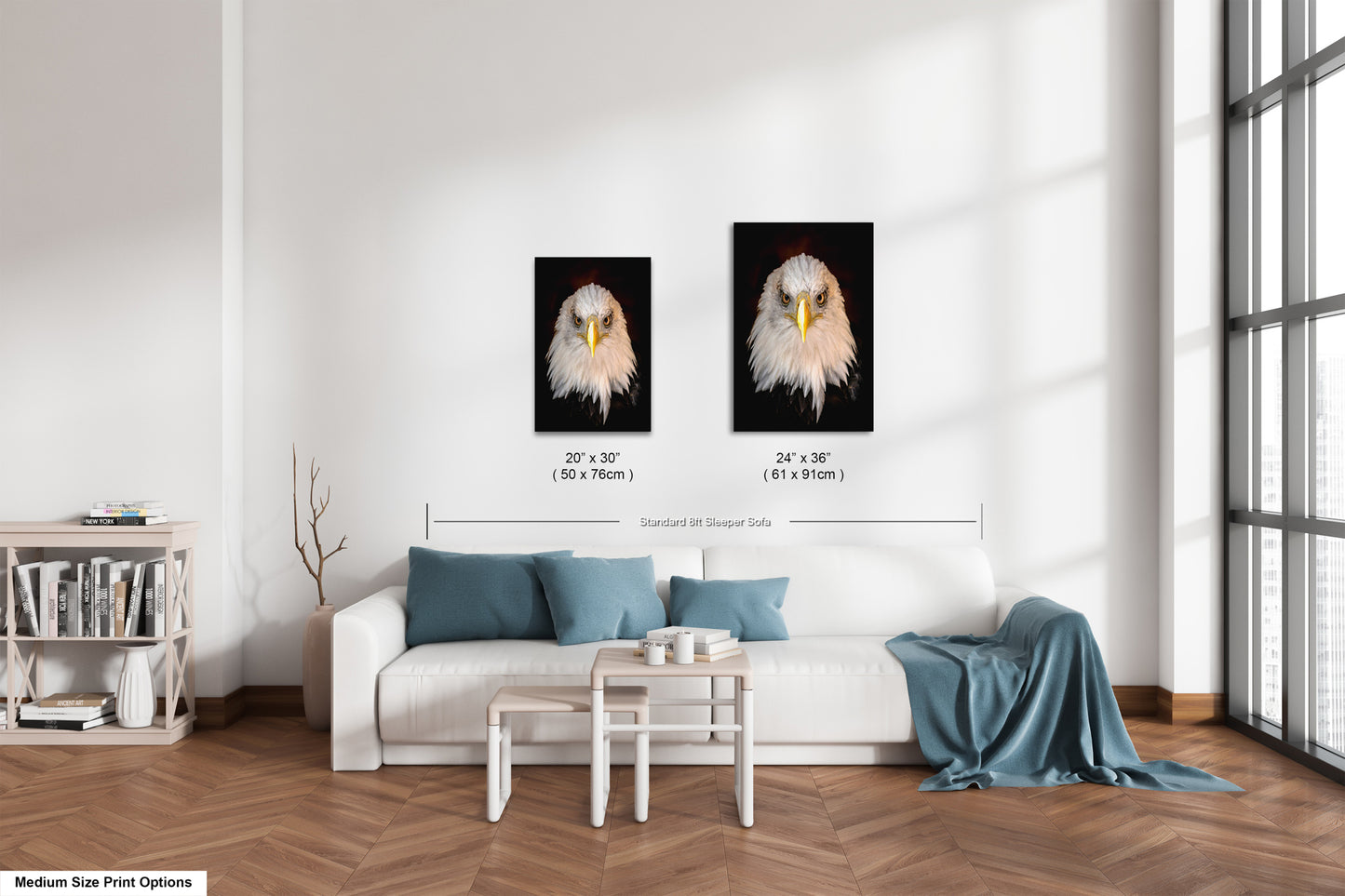 a living room with a white couch and two pictures on the wall