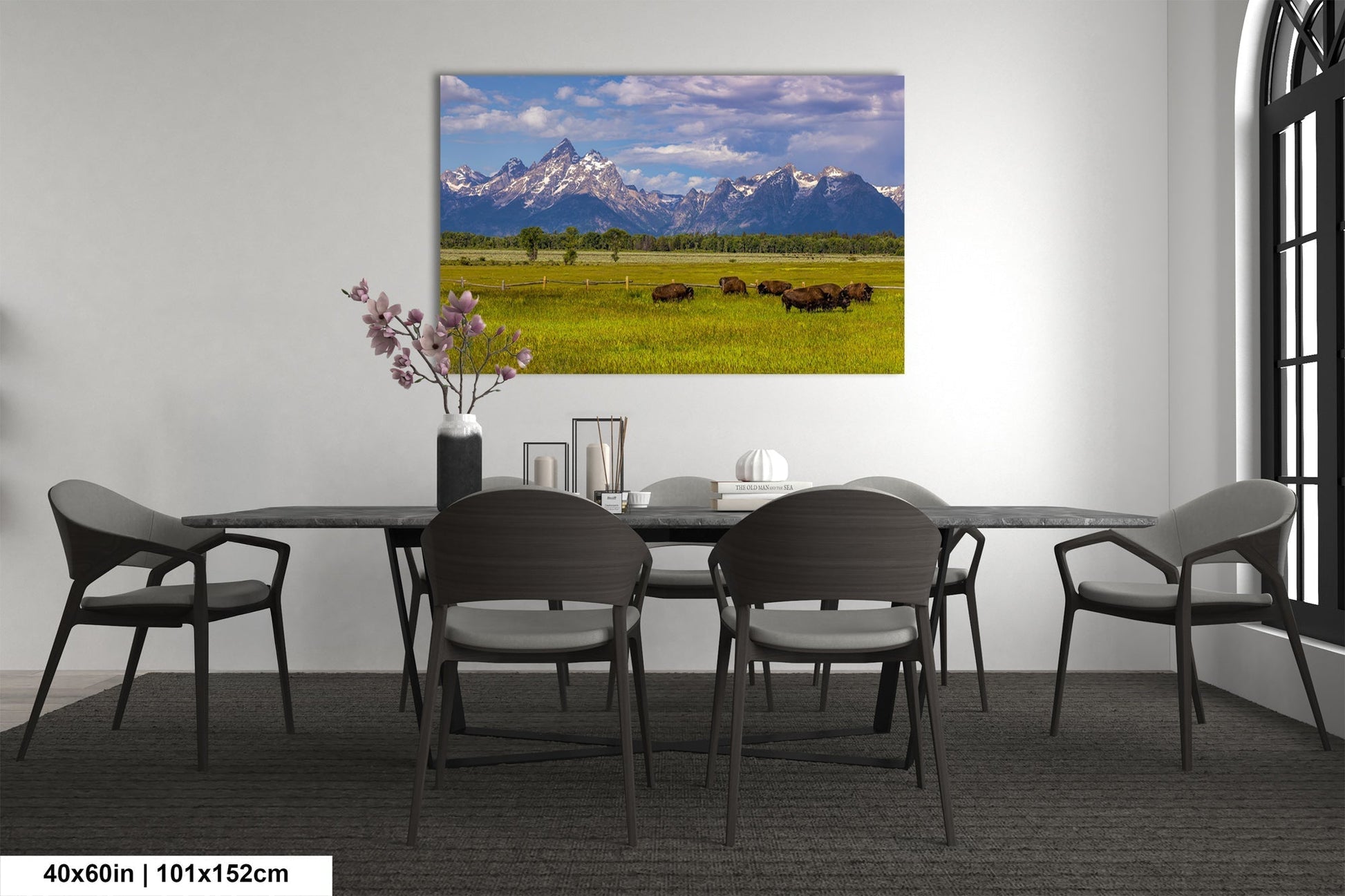 a dining room table with chairs and a painting on the wall