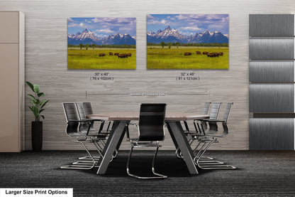 a dining room table with chairs in front of two pictures of mountains