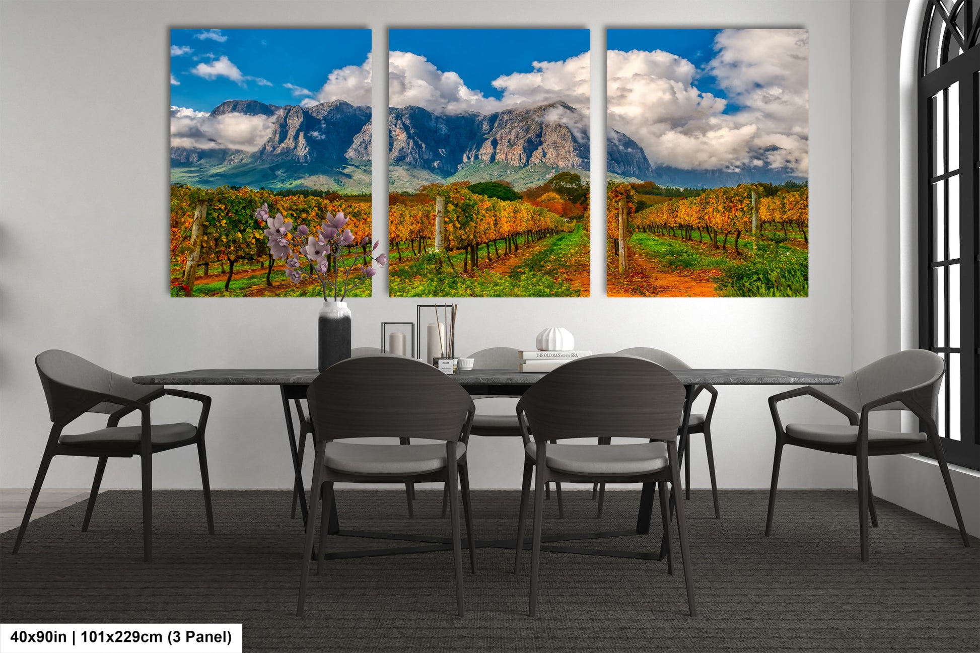 a dining room table with four chairs and a painting on the wall