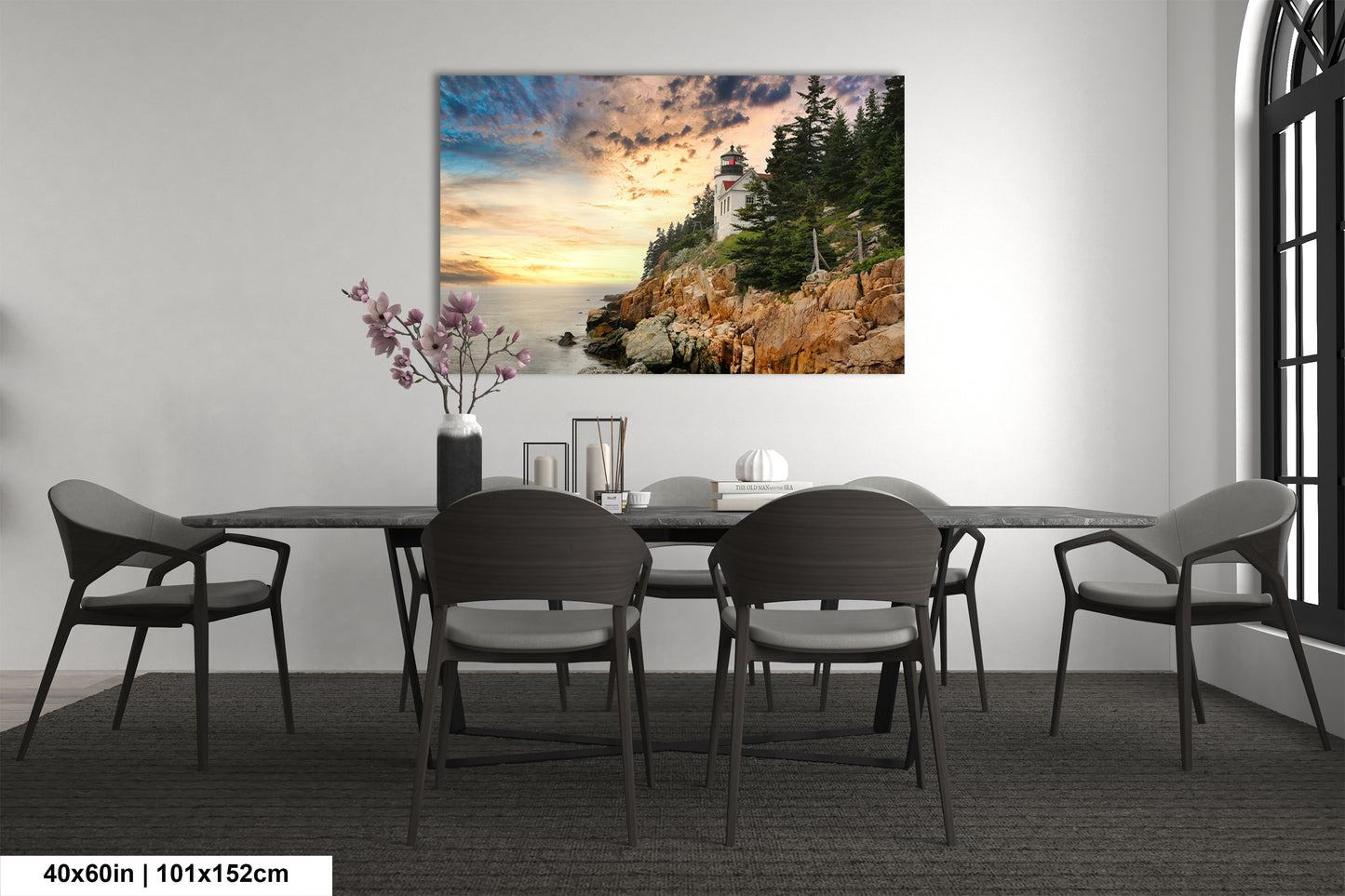 a dining room table with chairs and a painting on the wall