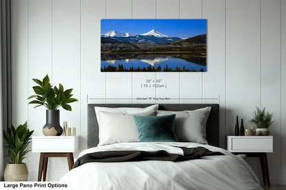 a bedroom with a large bed and a painting on the wall