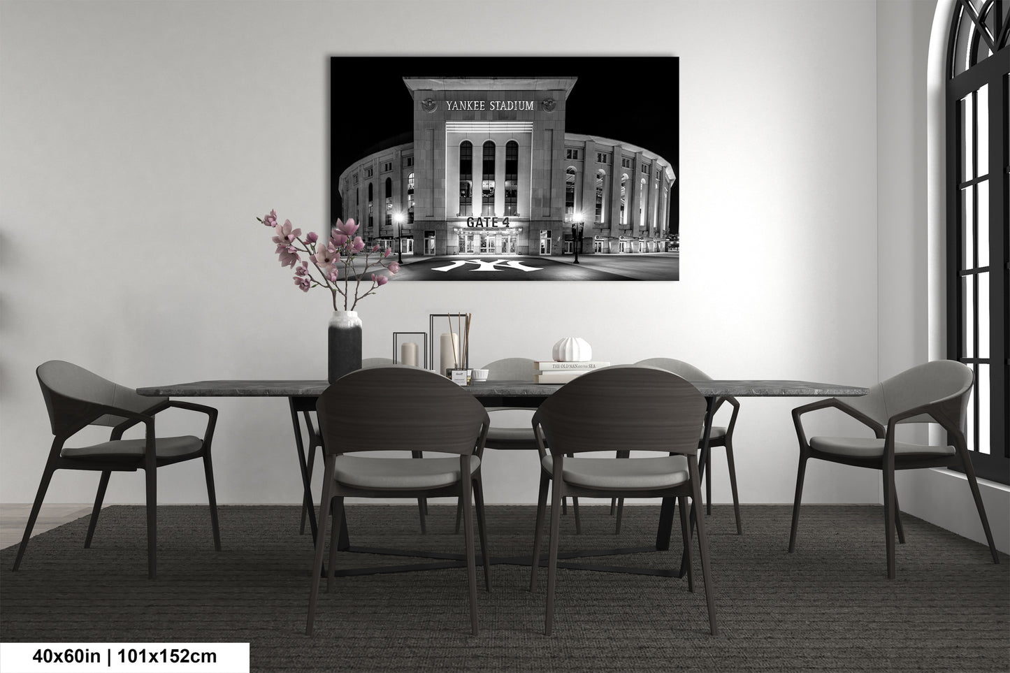 a large black and white photograph of the Yankee Stadium in New York City, with a table and chairs in front of it.