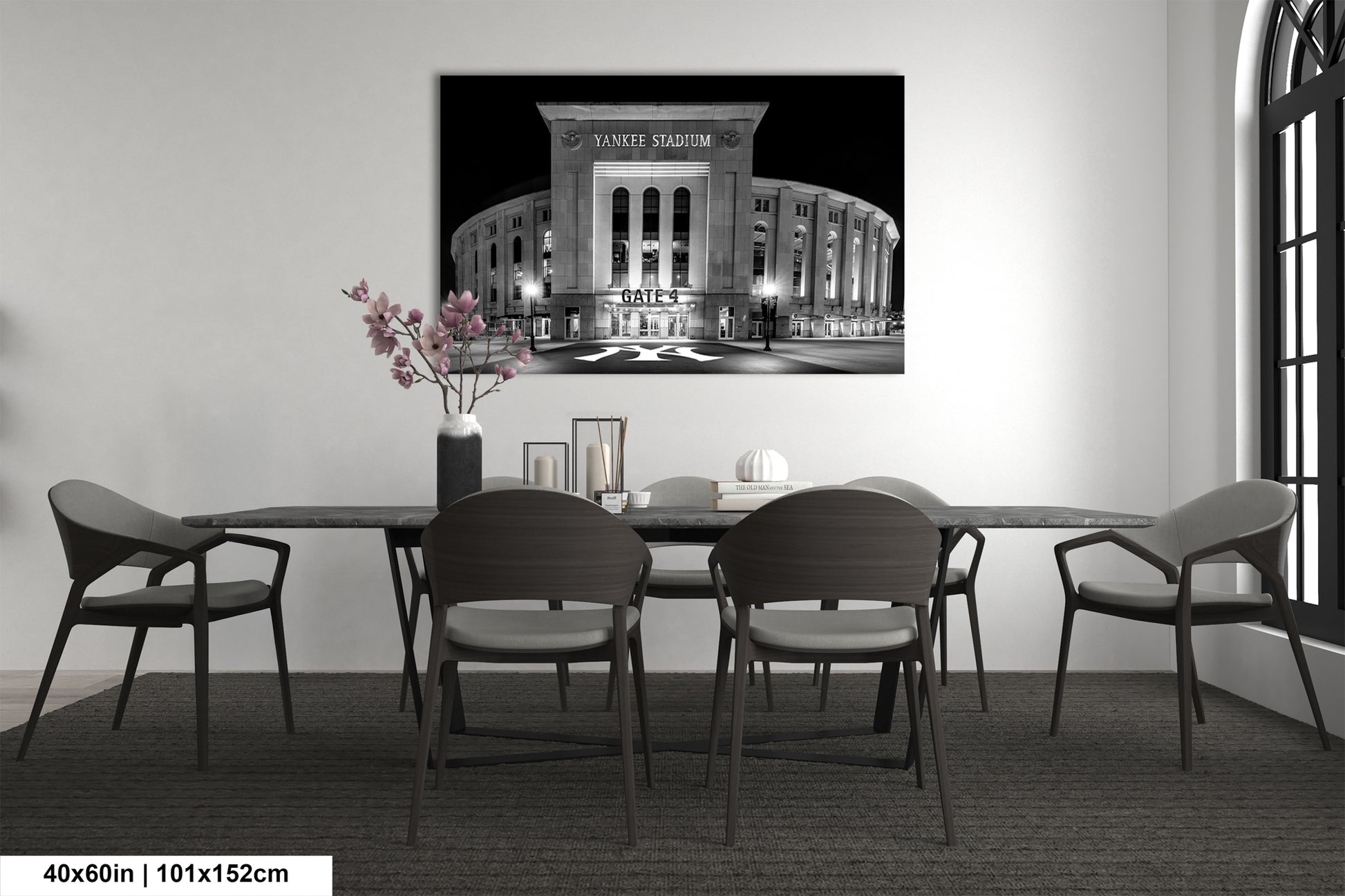 a large black and white photograph of the Yankee Stadium in New York City, with a table and chairs in front of it.