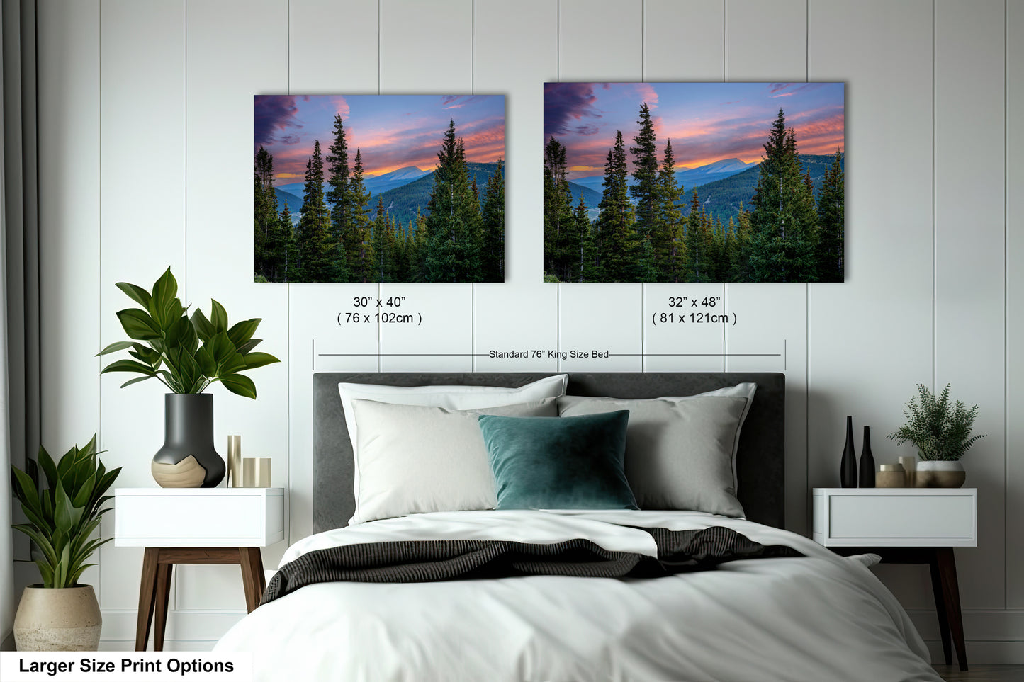 a bedroom with a large bed and two framed landscape photographs hanging on the wall above it. The photographs depict a scenic mountain landscape with pine trees and a colorful sunset sky.