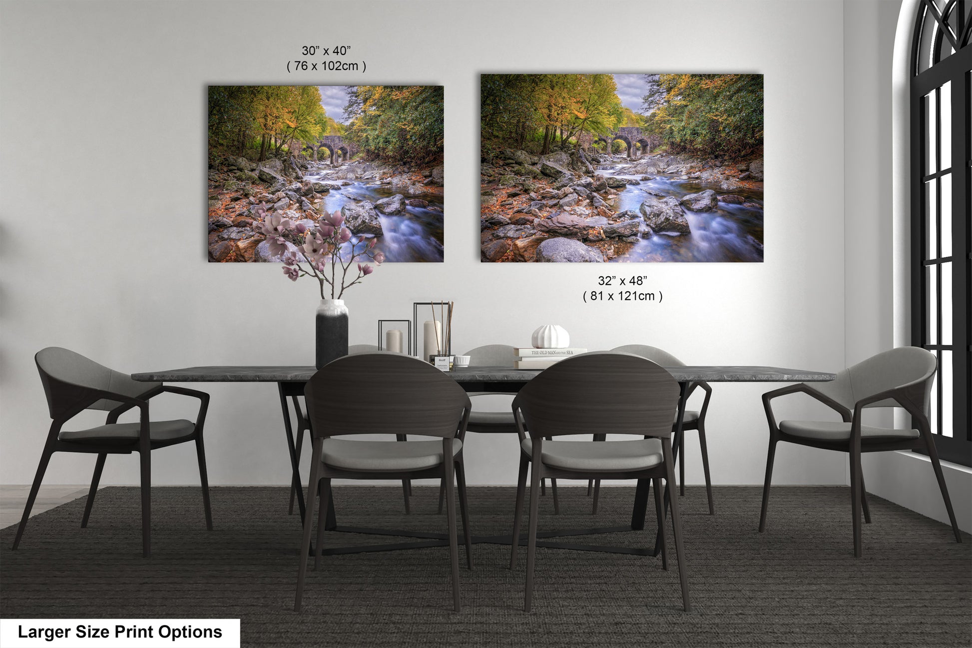 a dining room table with four chairs and two pictures on the wall