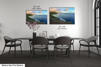 a dining room table with four chairs and a vase of flowers