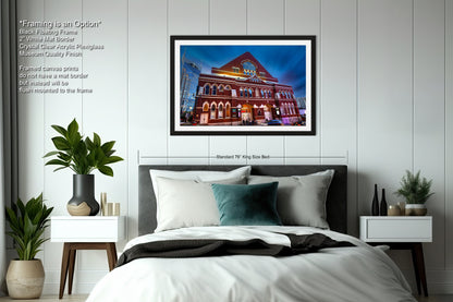 a bedroom with a bed and a picture hanging on the wall
