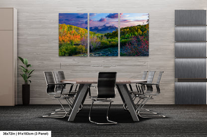a dining room table with chairs and a painting on the wall