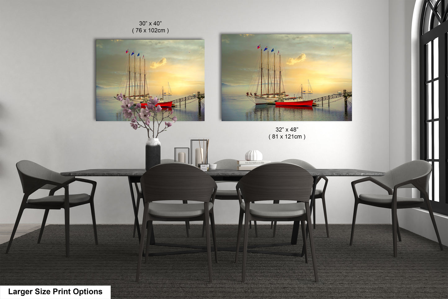 a dining room table with four chairs and a vase with flowers