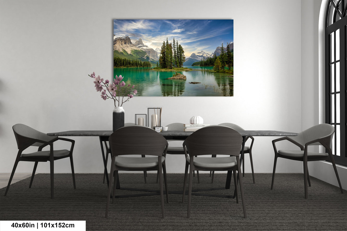 a dining room table with chairs and a painting on the wall