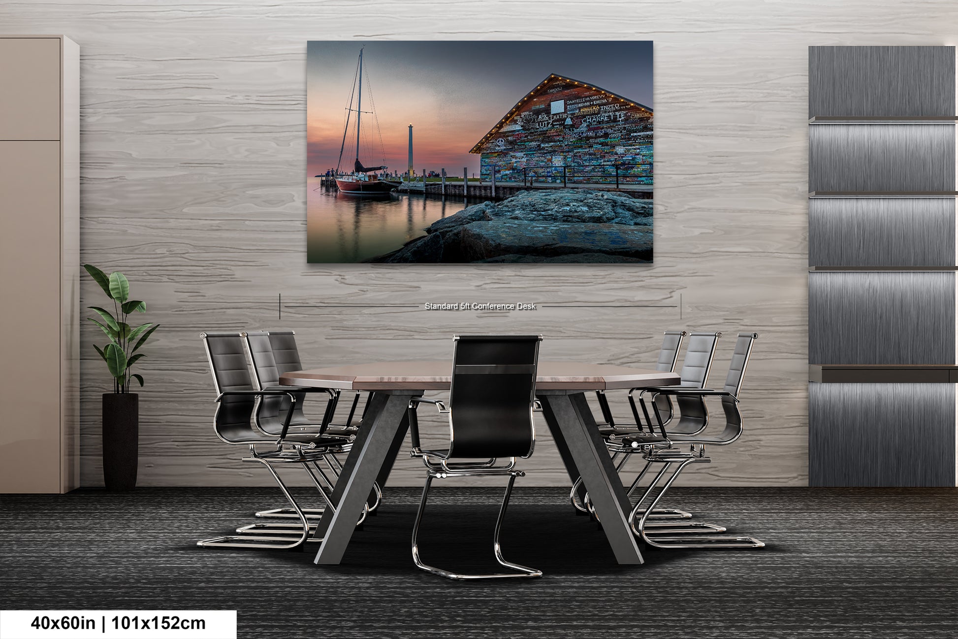 a modern office space with a large, colorful painting of a boat on a dock hanging on the wall. The painting is surrounded by a wooden wall and a gray carpeted floor. In front of the painting, there is a wooden table with several chairs arranged around it.