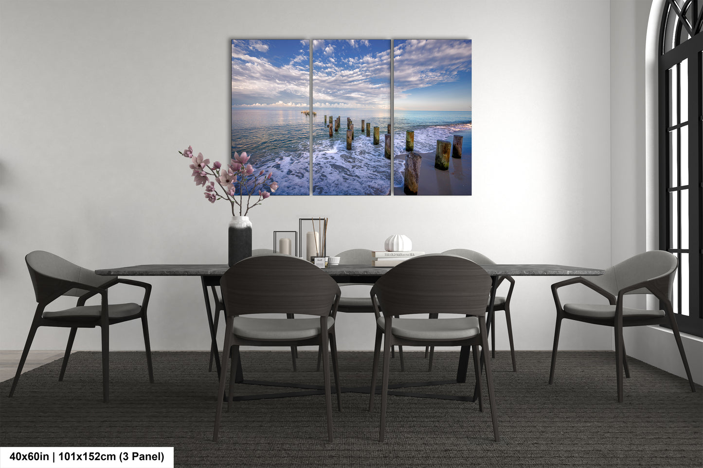 a dining room table with chairs and a painting on the wall