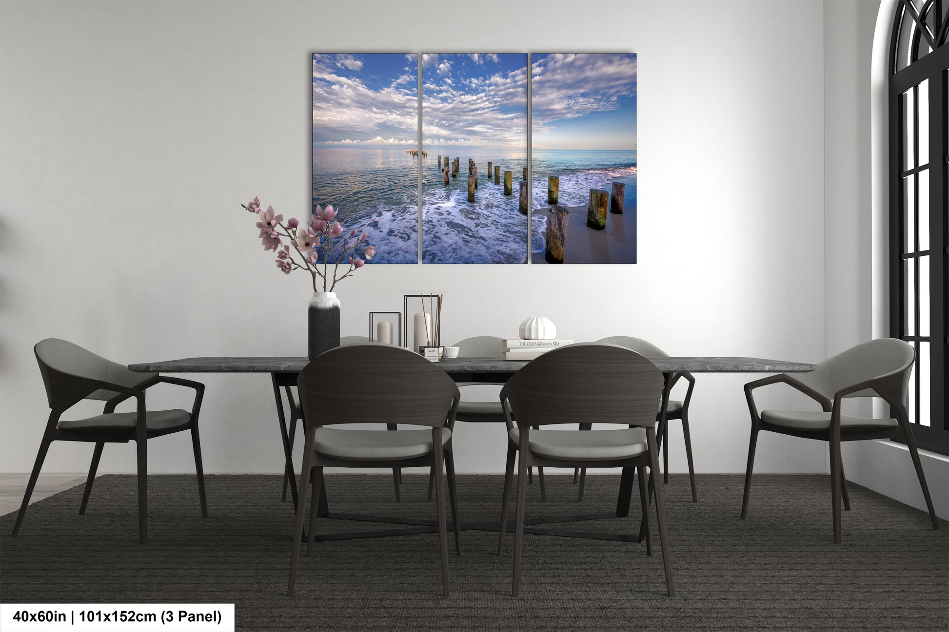 a dining room table with chairs and a painting on the wall