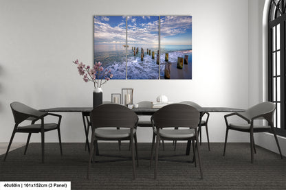 a dining room table with chairs and a painting on the wall