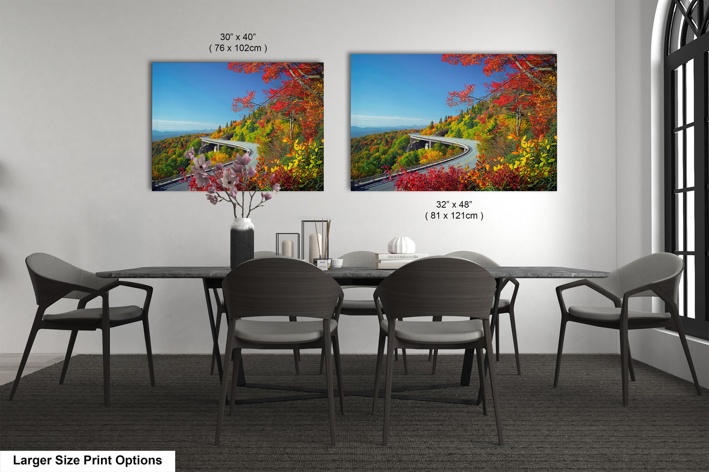 a dining room table with four chairs and a painting on the wall