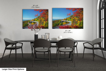 a dining room table with four chairs and a painting on the wall