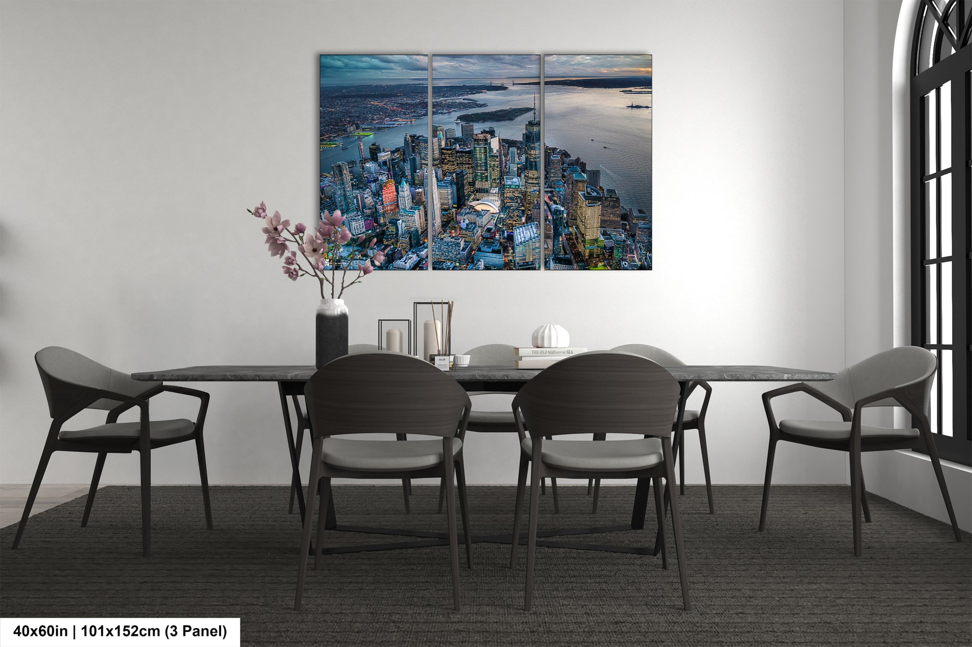 a dining room table with chairs and a painting on the wall