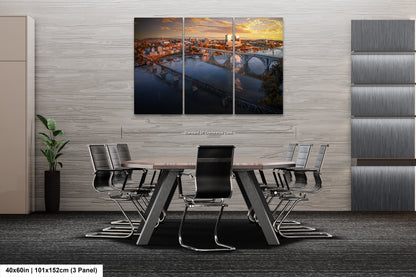 a dining room table with chairs and a painting on the wall