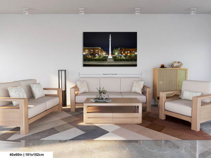 a living room filled with furniture and a painting on the wall