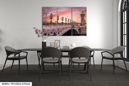 a dining room table with chairs and a painting on the wall