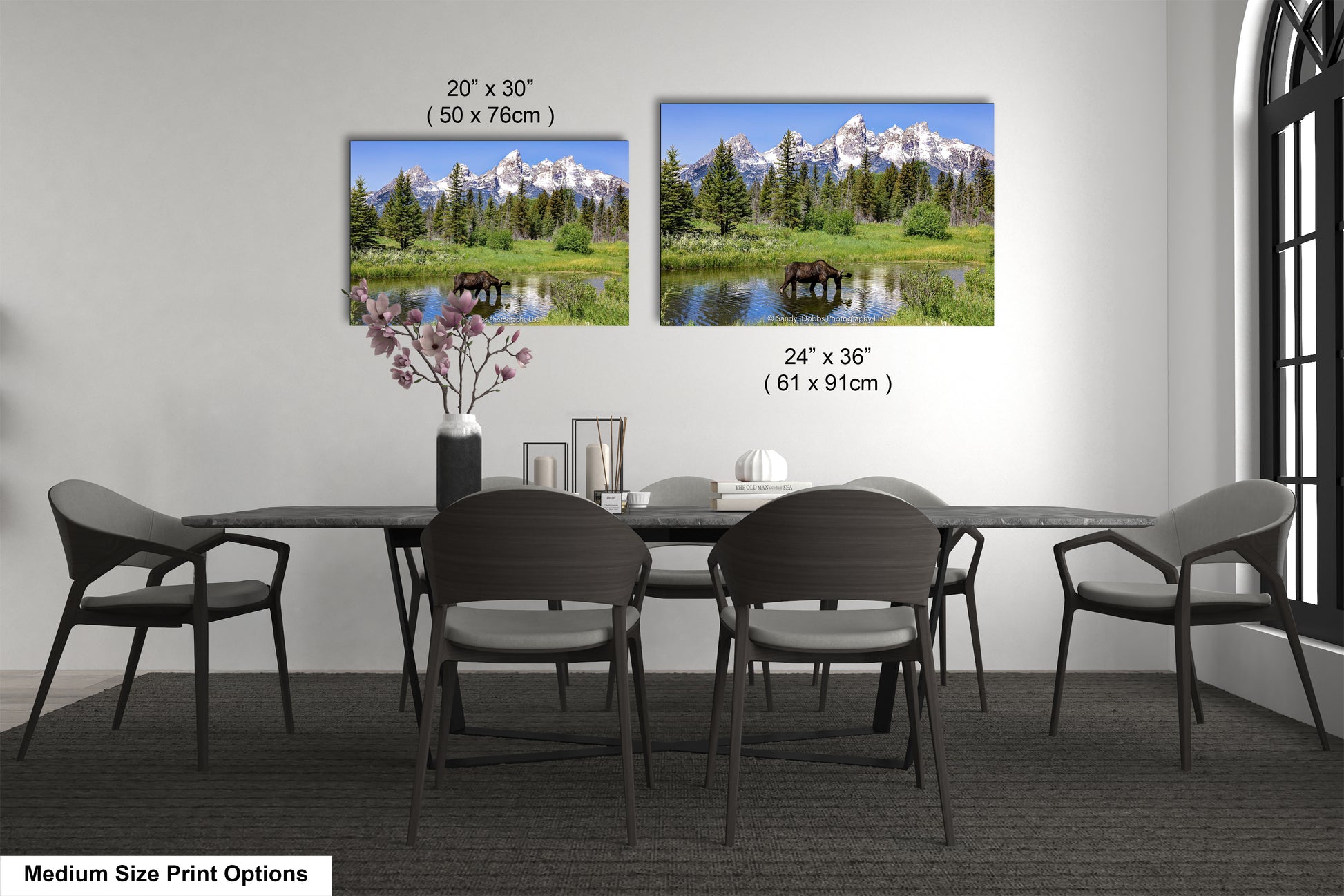 a dining room table with four chairs and a vase of flowers