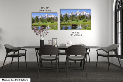 a dining room table with four chairs and a vase of flowers