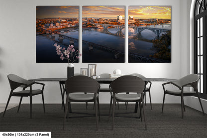 a dining room table with four chairs and a painting on the wall