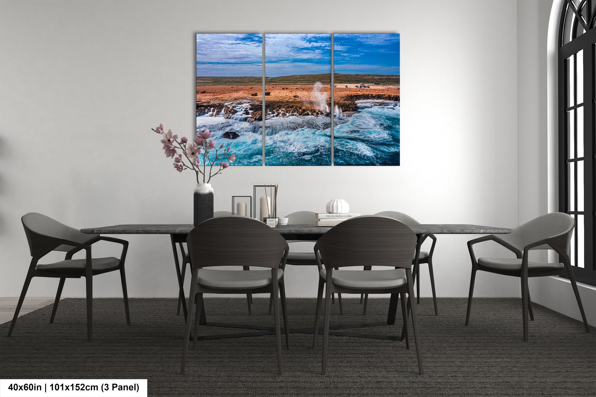 a dining room table with four chairs and a painting on the wall