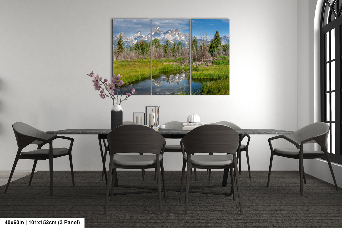 a dining room table with chairs and a painting on the wall