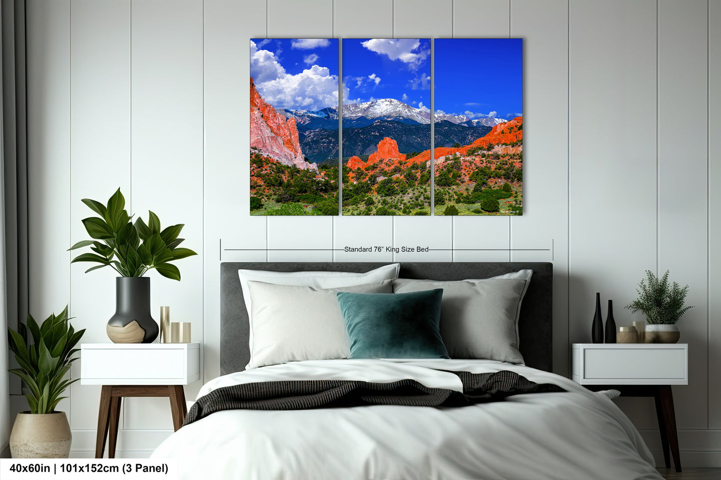 a bed room with a neatly made bed and a painting on the wall