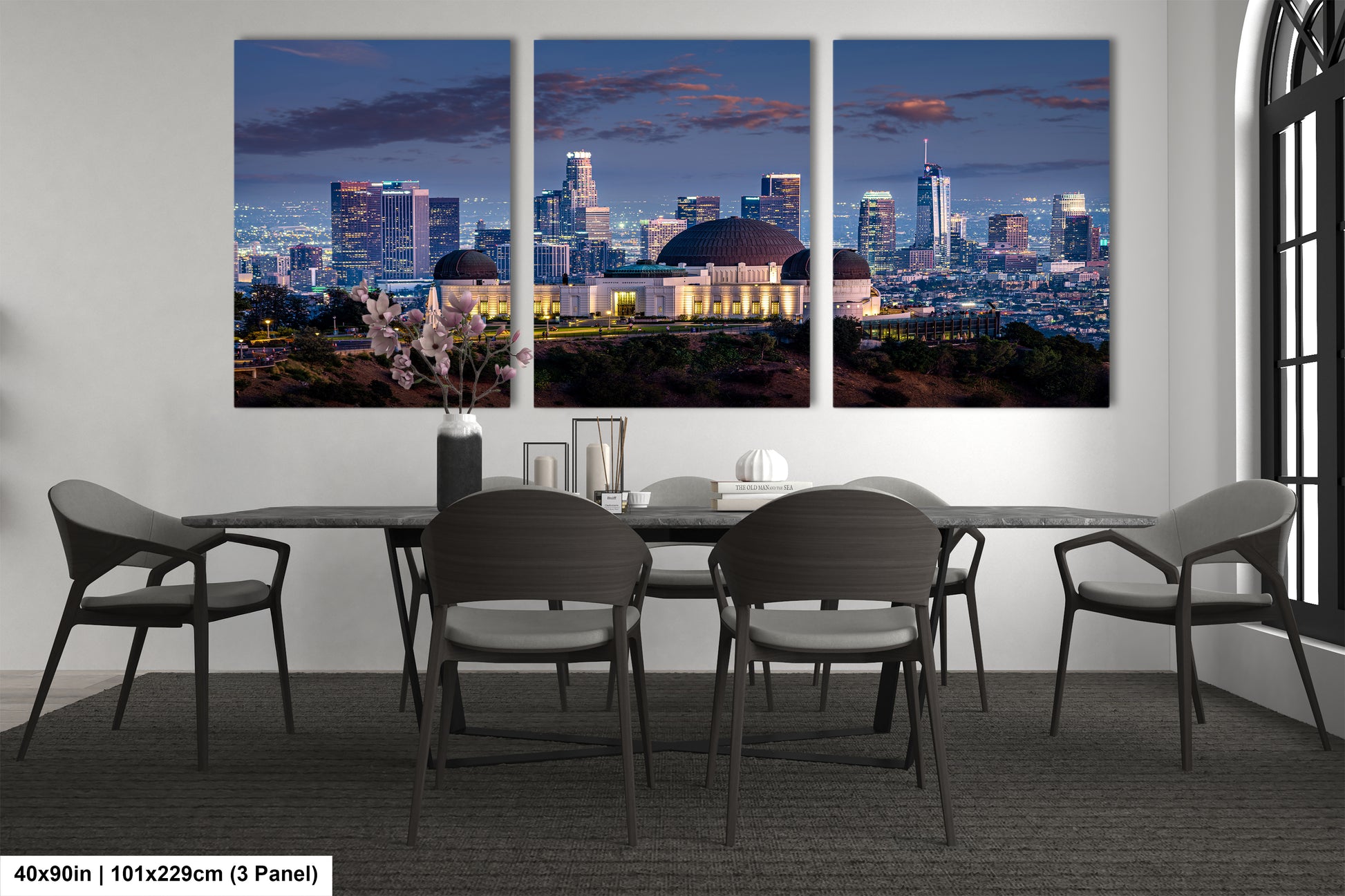 a dining room table with four chairs and a view of a city