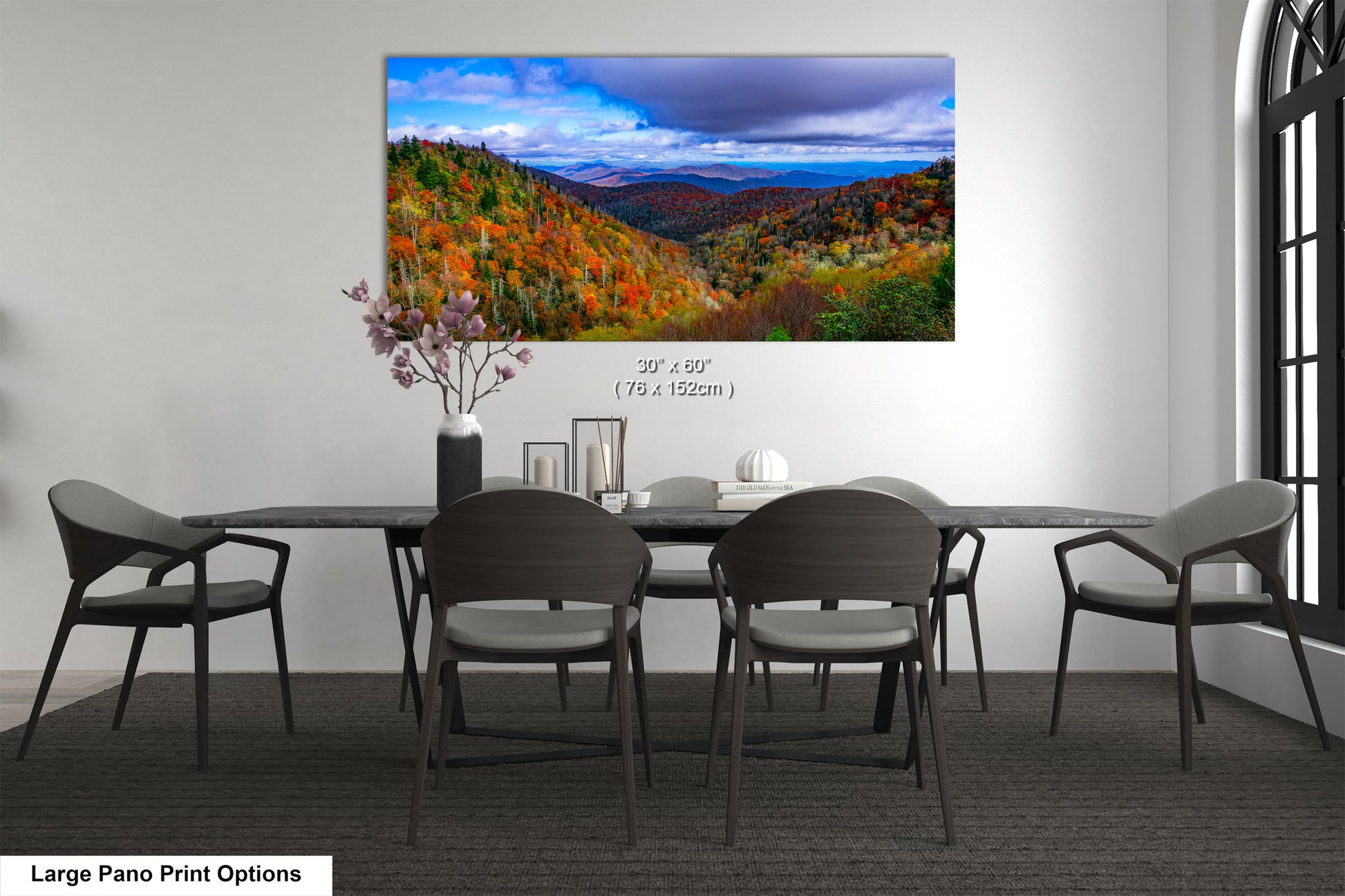 a dining room table with chairs and a painting on the wall