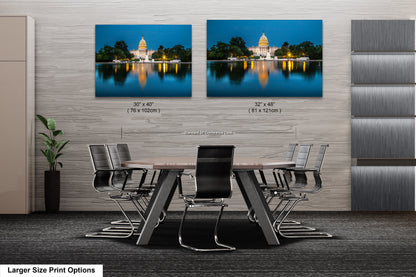 a dining room table with chairs in front of a wall with two pictures of a