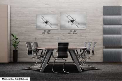 a dining room table with chairs and pictures on the wall