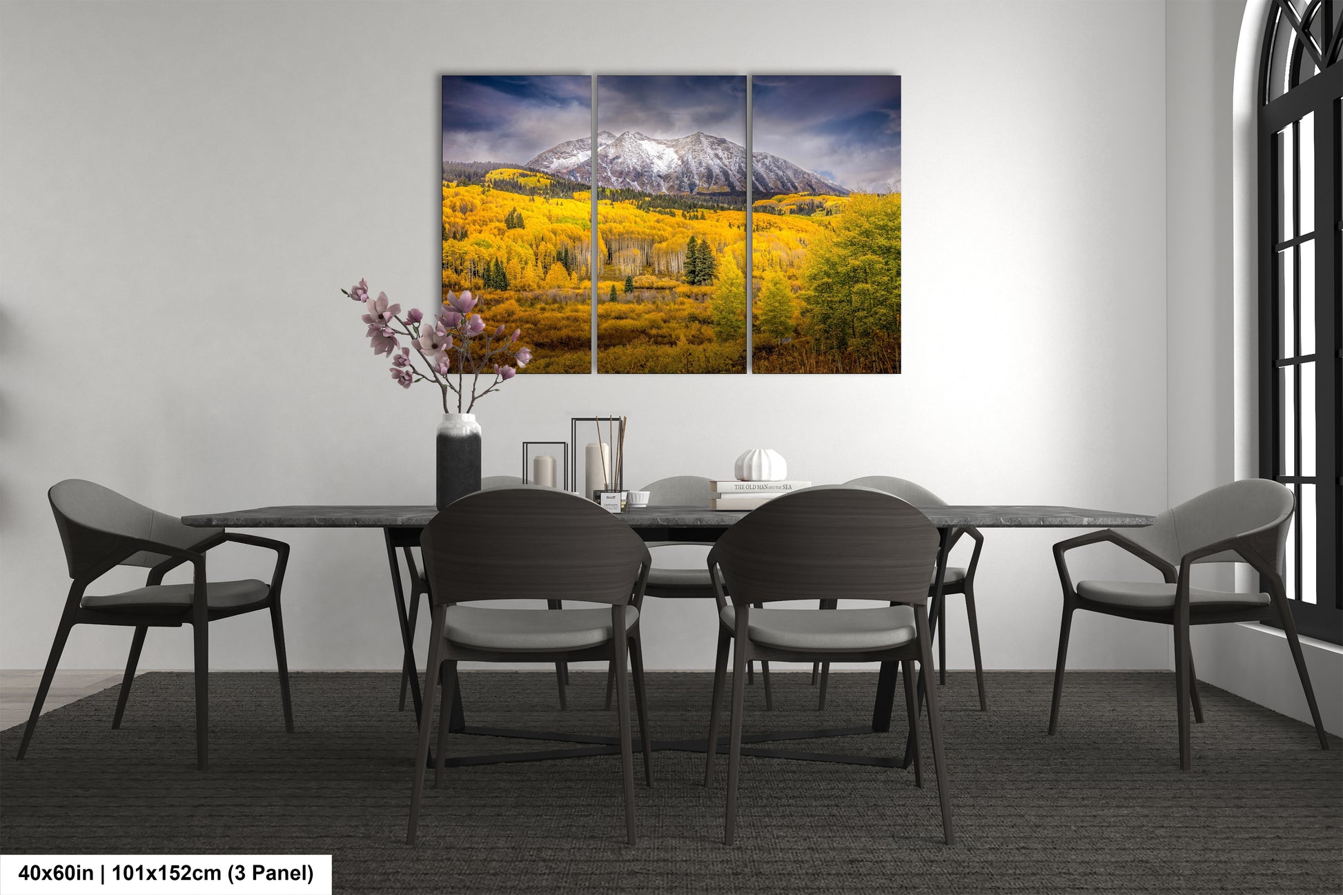 a dining room table with chairs and a painting on the wall