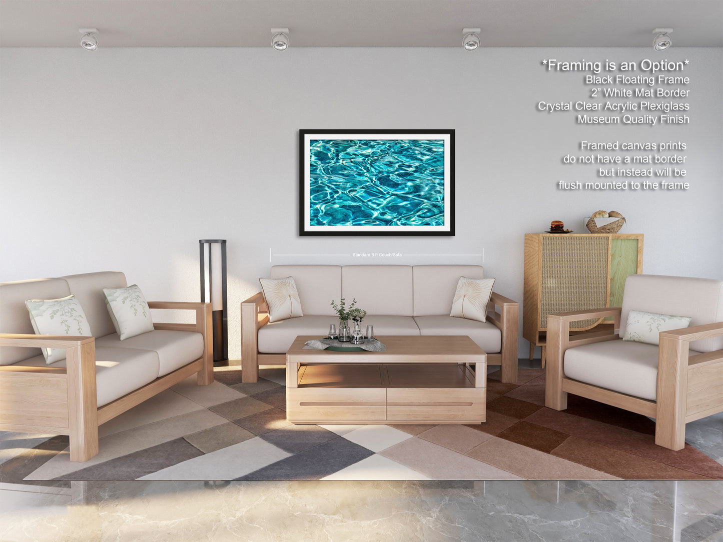 a modern living room with a white sofa, two matching armchairs, and a wooden coffee table. The room has a geometric patterned rug on the floor, and a framed artwork of a blue and green water surface hangs on the wall.