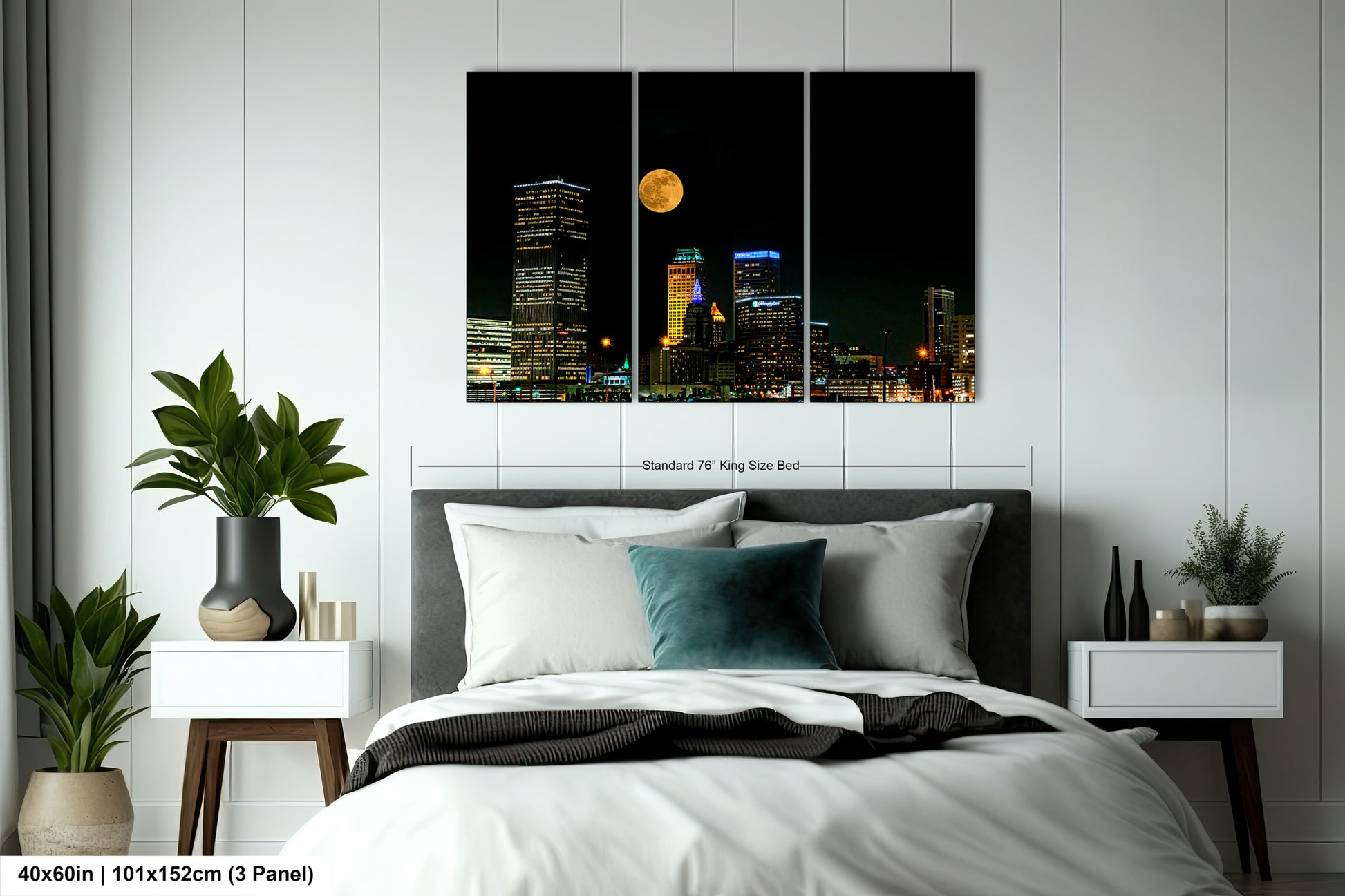a bedroom with a bed and a night view of a city