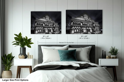 a bed with two pictures on the wall above it