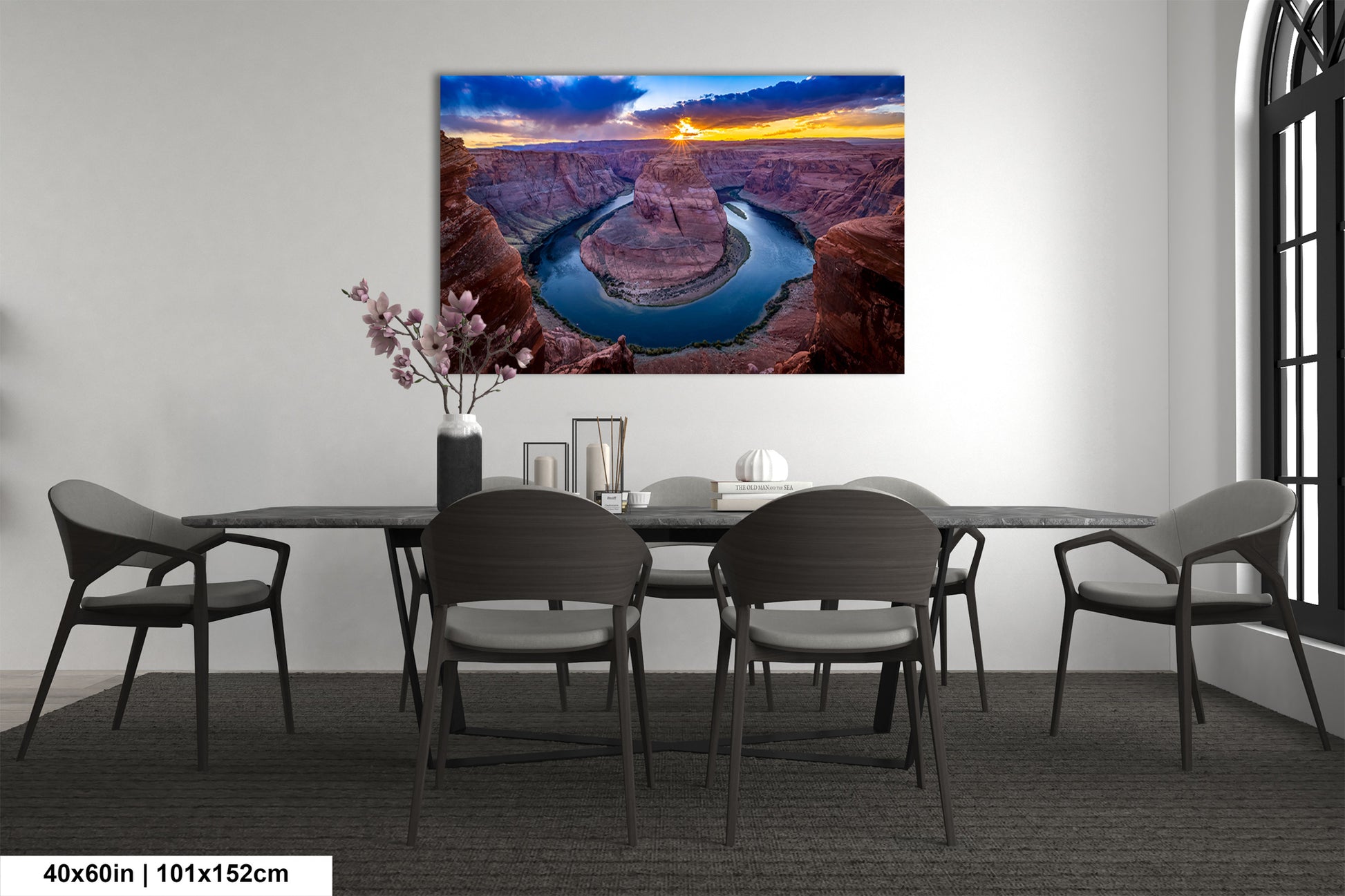 a dining room table with chairs and a painting on the wall
