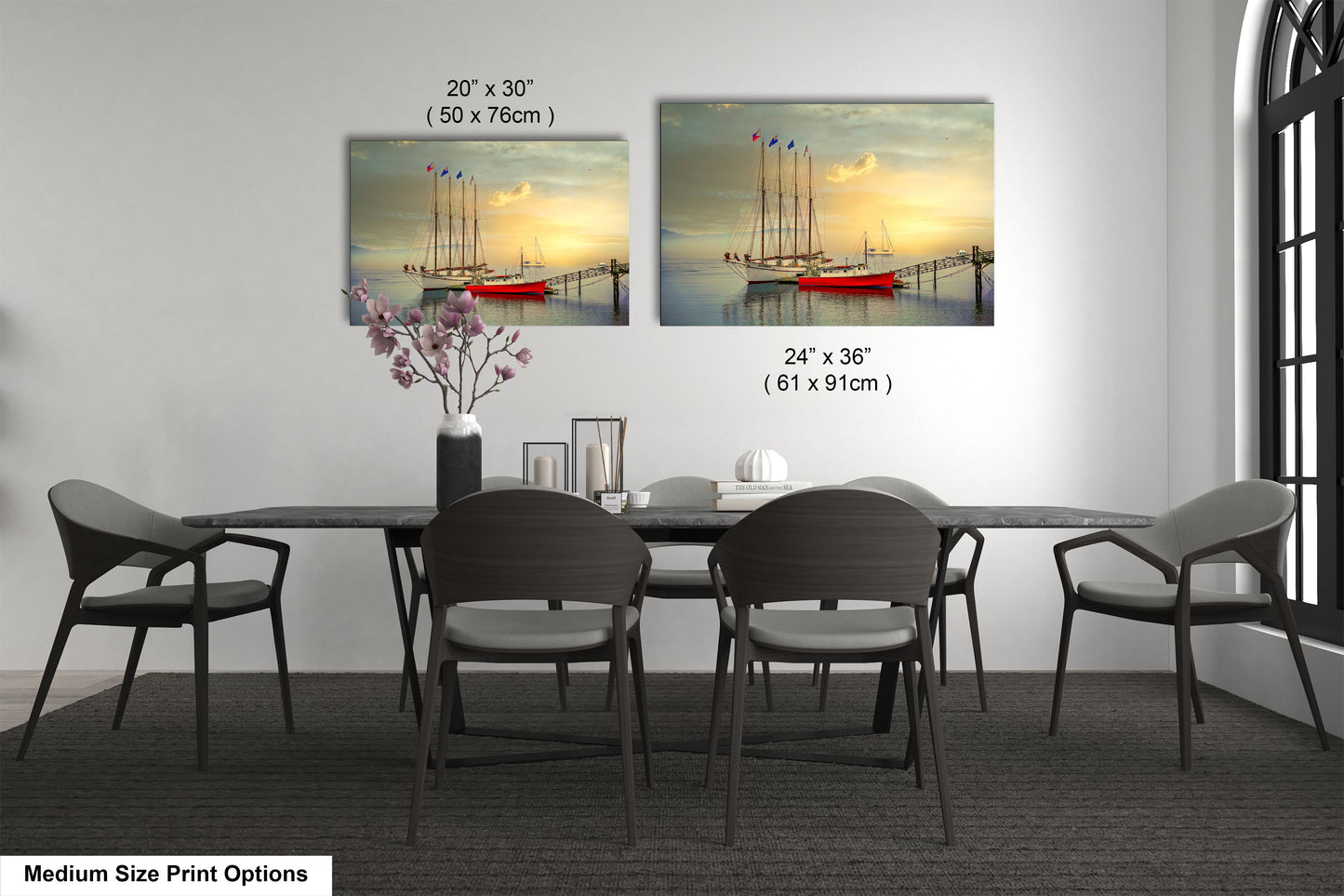 a dining room table with four chairs and a vase of flowers