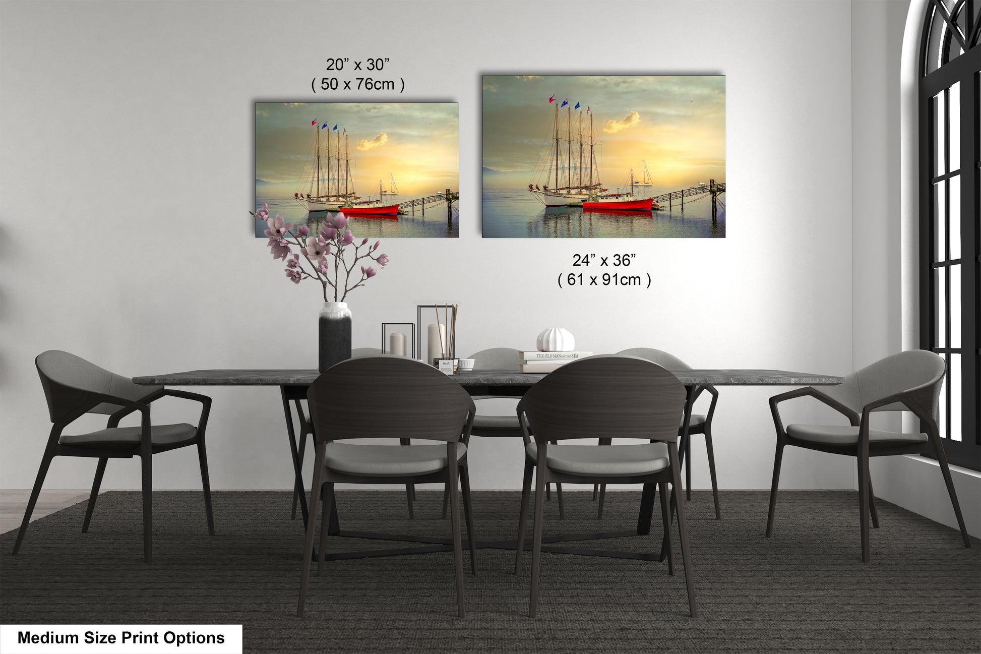 a dining room table with four chairs and a vase of flowers