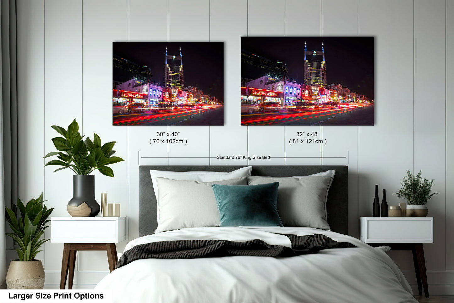 a bed with two pictures on the wall above it