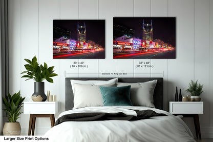 a bed with two pictures on the wall above it